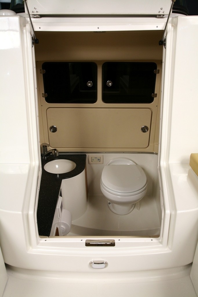 Head, shower cleverly concealed just forward of the helm station, outstandng use of available space. - Chris-Craft Sun Tender © supplied by Chris-Craft